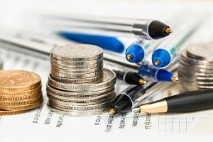 Picture of coins, pens and financial printout